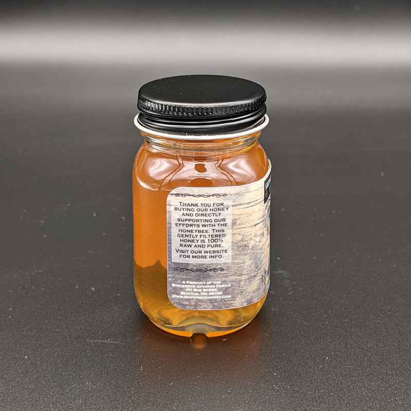 Shipwreck Honey Raw Honey 2oz Jar in Wildflower Blossom Honey Side Jar 'Thank you for buying our honey and directly supporting our efforts with the honeybee.'