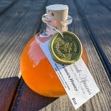 Shipwreck Apiaries Raw Honey 8oz glass flagon in both Blackberry Blossom Honey or Wildflower Blossom Honey Outdoor View