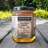 Shipwreck Honey Raw Honey 9oz hex jars in signature Wildflower Blossom Honey Front Label Outdoors - A Seattle Honeybee Company